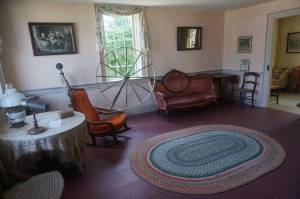 The parlor features a spinning wheel, antique grandfather clock (not pictured), and mourning handkerchiefs from the death of George Washington.