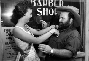 Beauty Queen Pat Stewart tries her hand at trimming Bev Greenlaw's beard. 